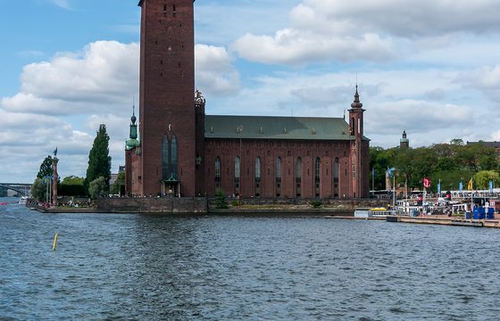 Stockholm City Hall and its brick tower seen across the water