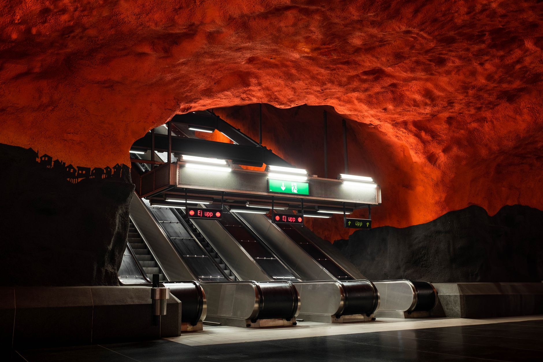 Explore the vibrant red cave-like art installation at Stockholm's Solna Centrum metro station.