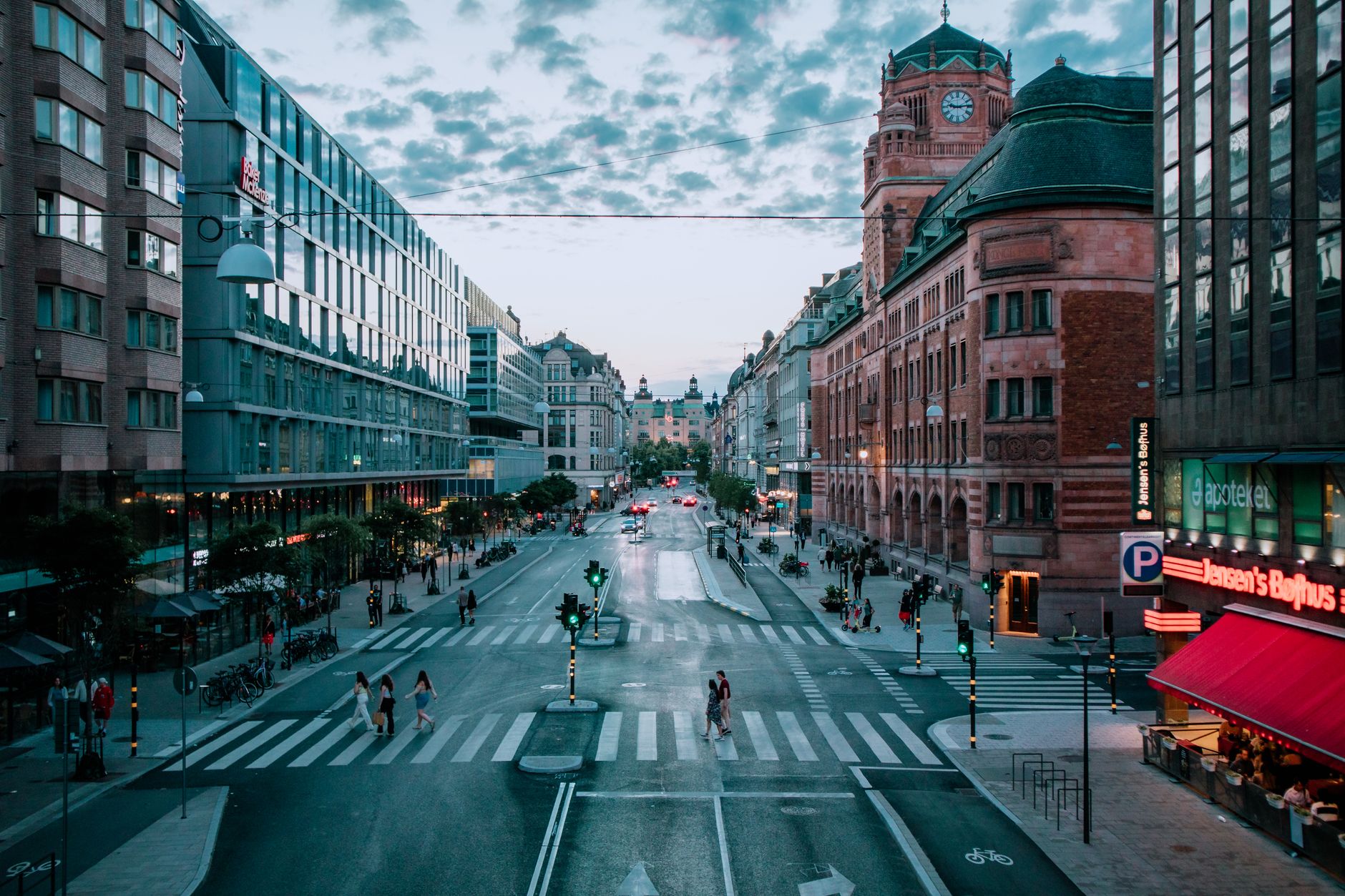 A vibrant evening cityscape of Stockholm with historic architecture and bustling streets. — illustrating How Does Tipping Work in Sweden? A Practical Guide