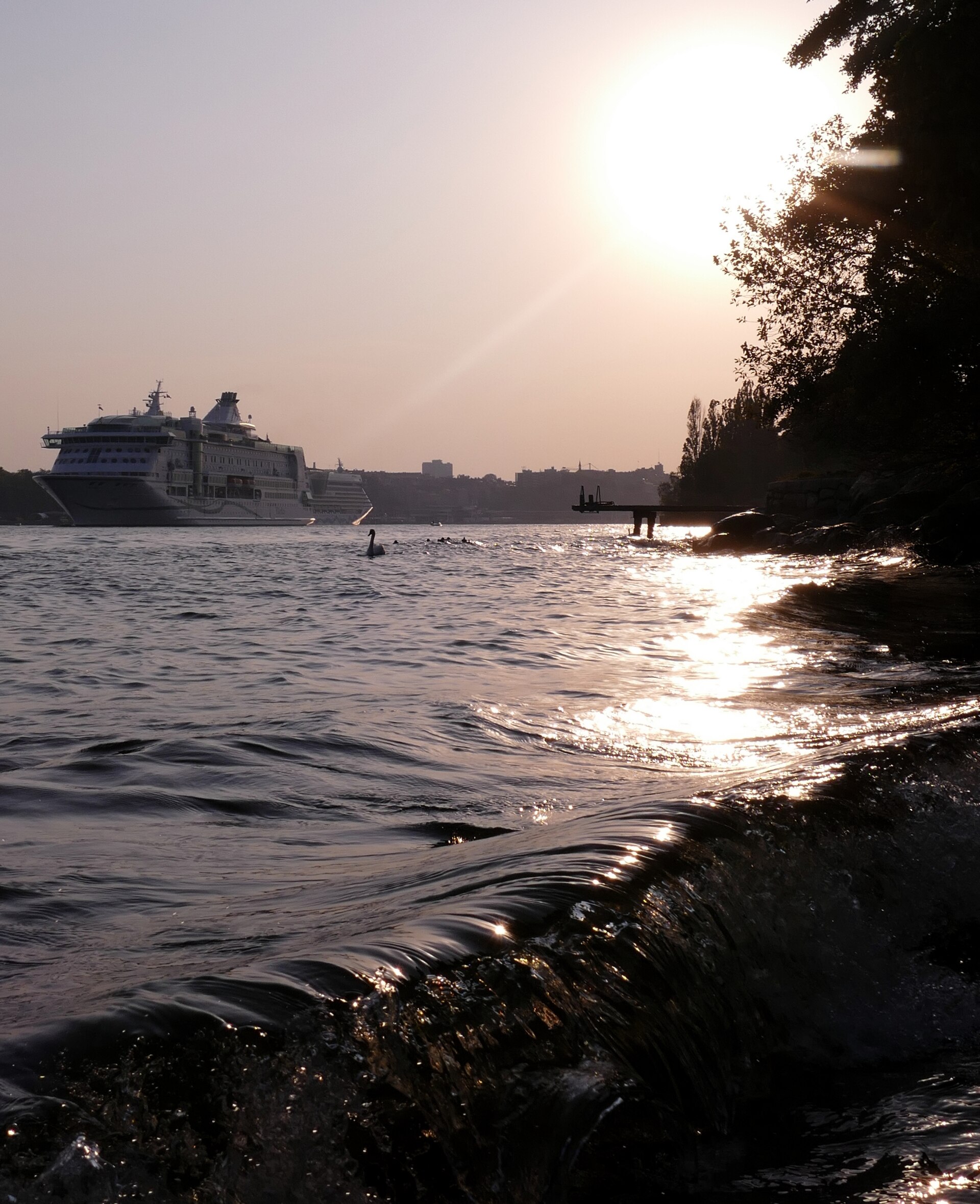 Evening view from Södra Djurgården towards central Stockholm, with the ship Birka Gotland