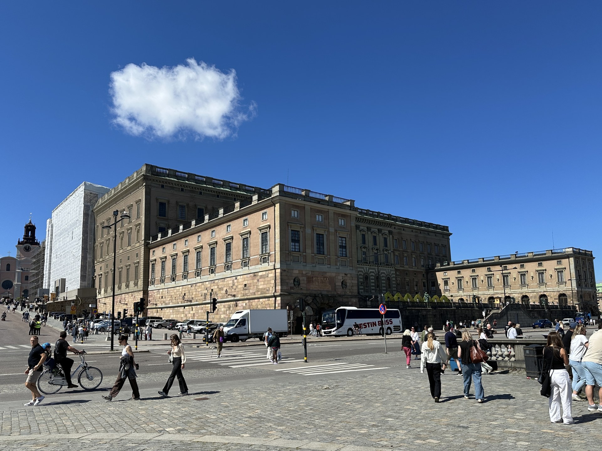 The Royal Palace of Stockholm at Slottsbacken, with people crossing in front