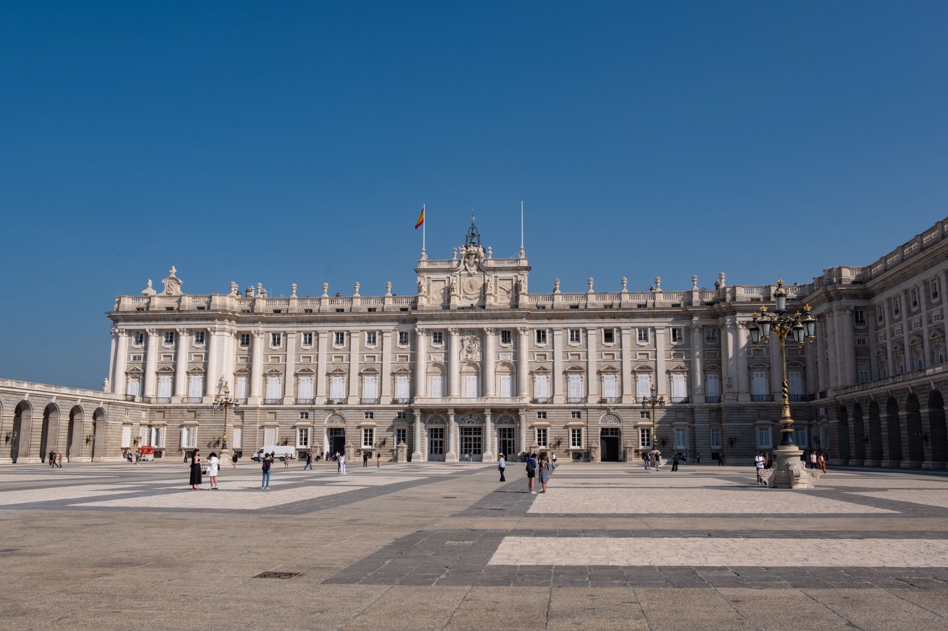 The Royal Palace of Madrid, a grand architectural landmark under a clear blue sky.