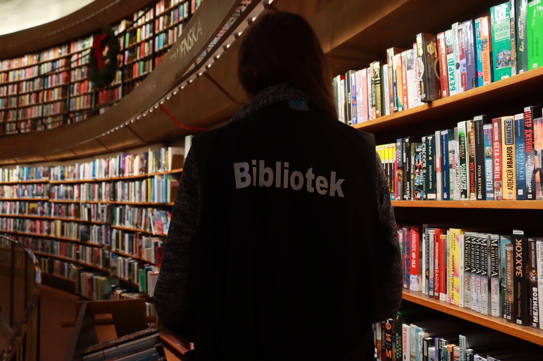 Librarian browsing bookshelves in Stockholm's iconic public library