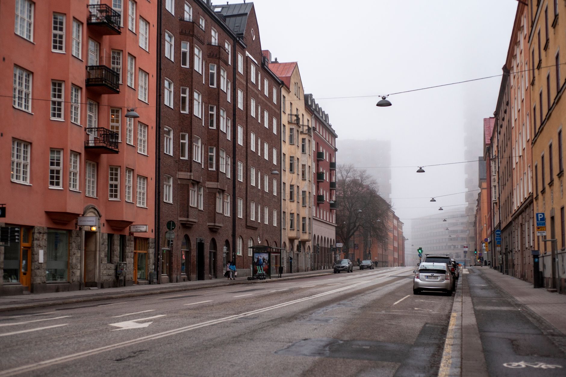 Foggy urban street with colorful buildings in Stockholm, Sweden, showcasing architecture and an empty atmosphere. — illustrating What Is Systembolaget, and Why Does It Exist?