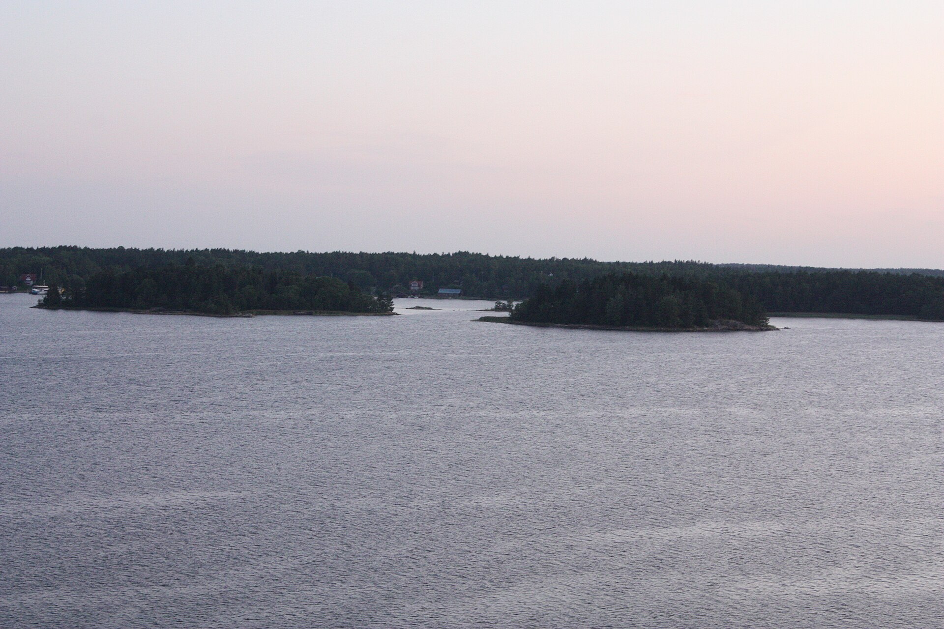 Rocky, wooded islets lining the cruise ship channel towards Stockholm