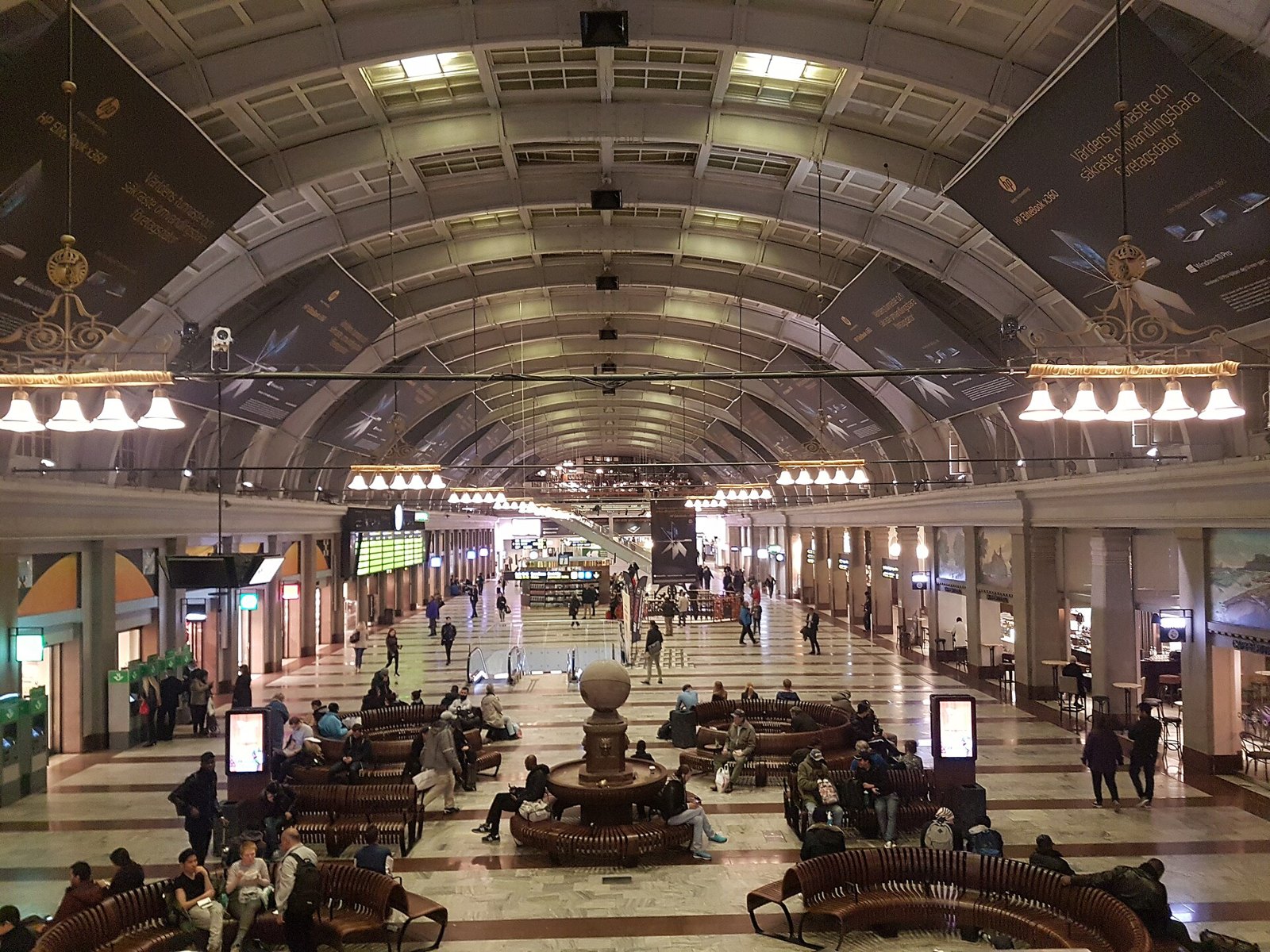 The main hall of Stockholm Central Station, with benches and departure boards